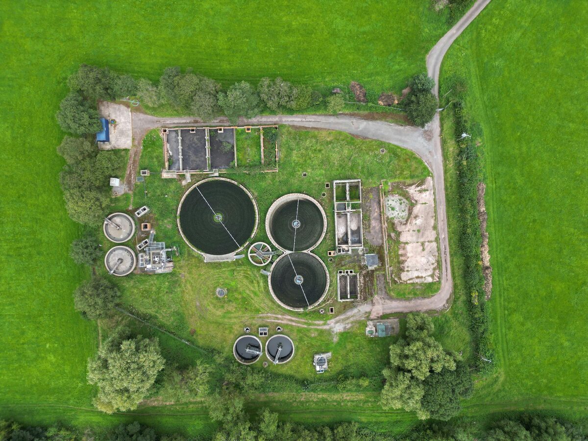 Aerial view of a wastewater treatment facility with circular settling tanks