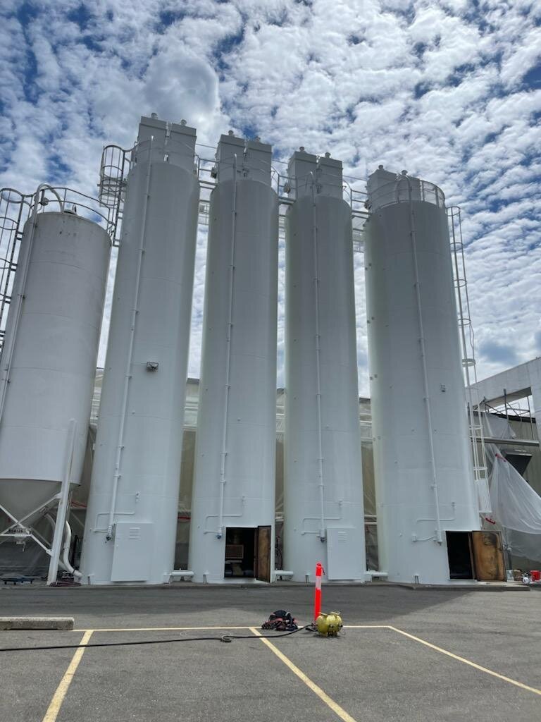 Chemical plant tank repaint — side view showing completed coating
