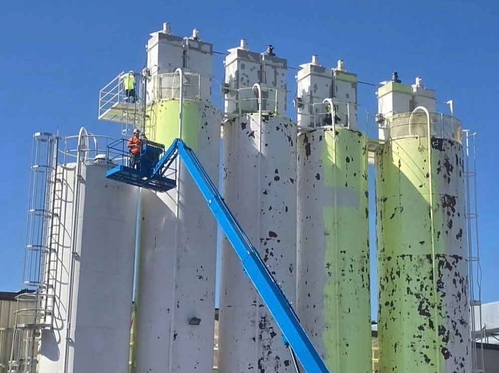 Chemical plant tank repaint — facility overview showing multiple tanks in completed condition