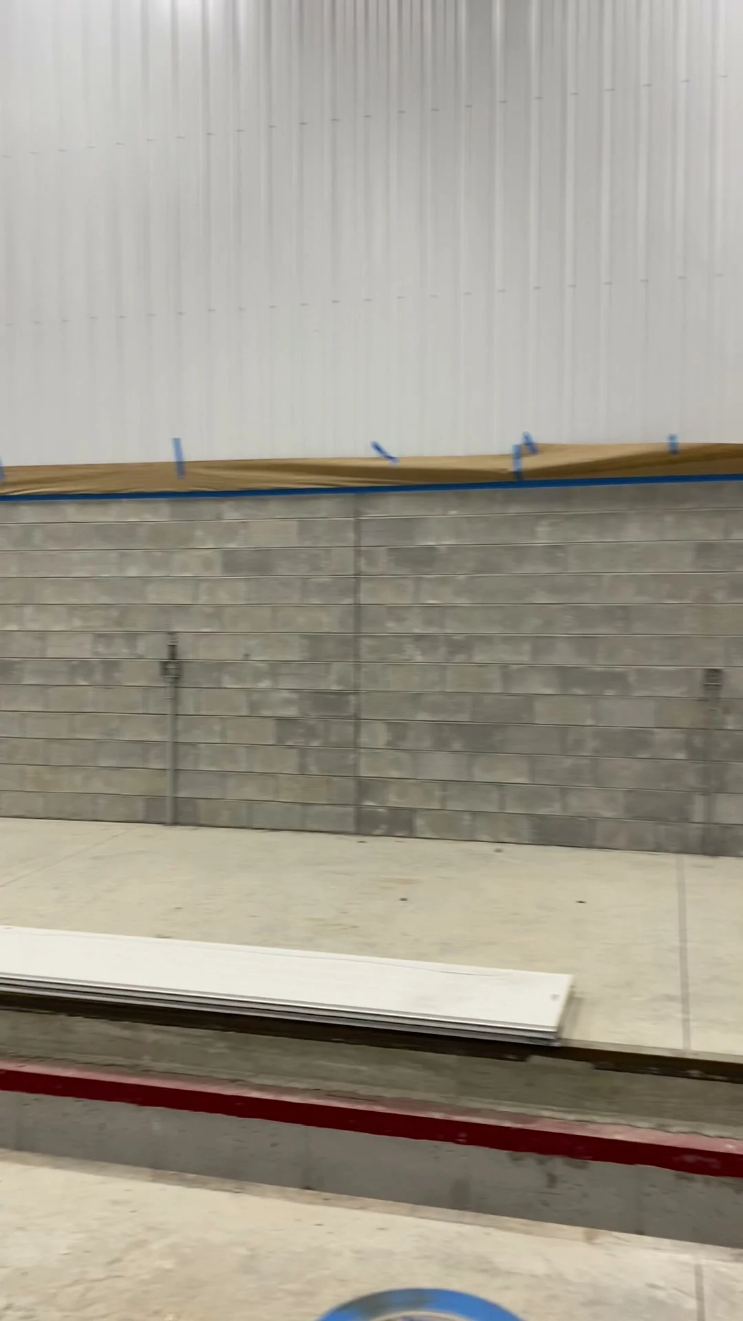 Before — bare CMU block wall showing rough, porous block surface prior to filling