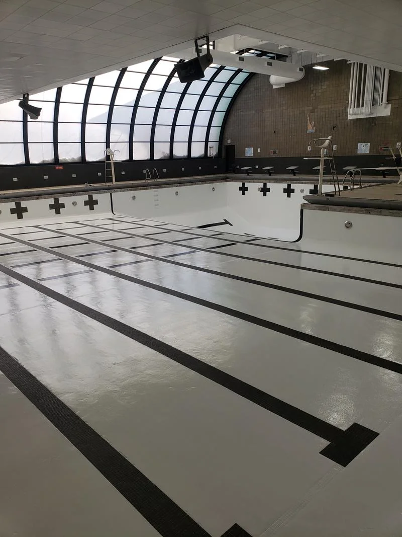 Freshly recoated indoor competition pool with lane lines and target markings