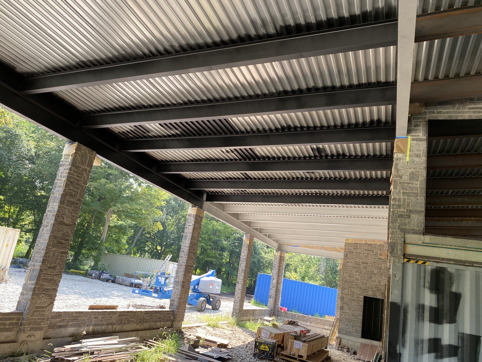 Underside of container house roof deck with painted black structural steel
