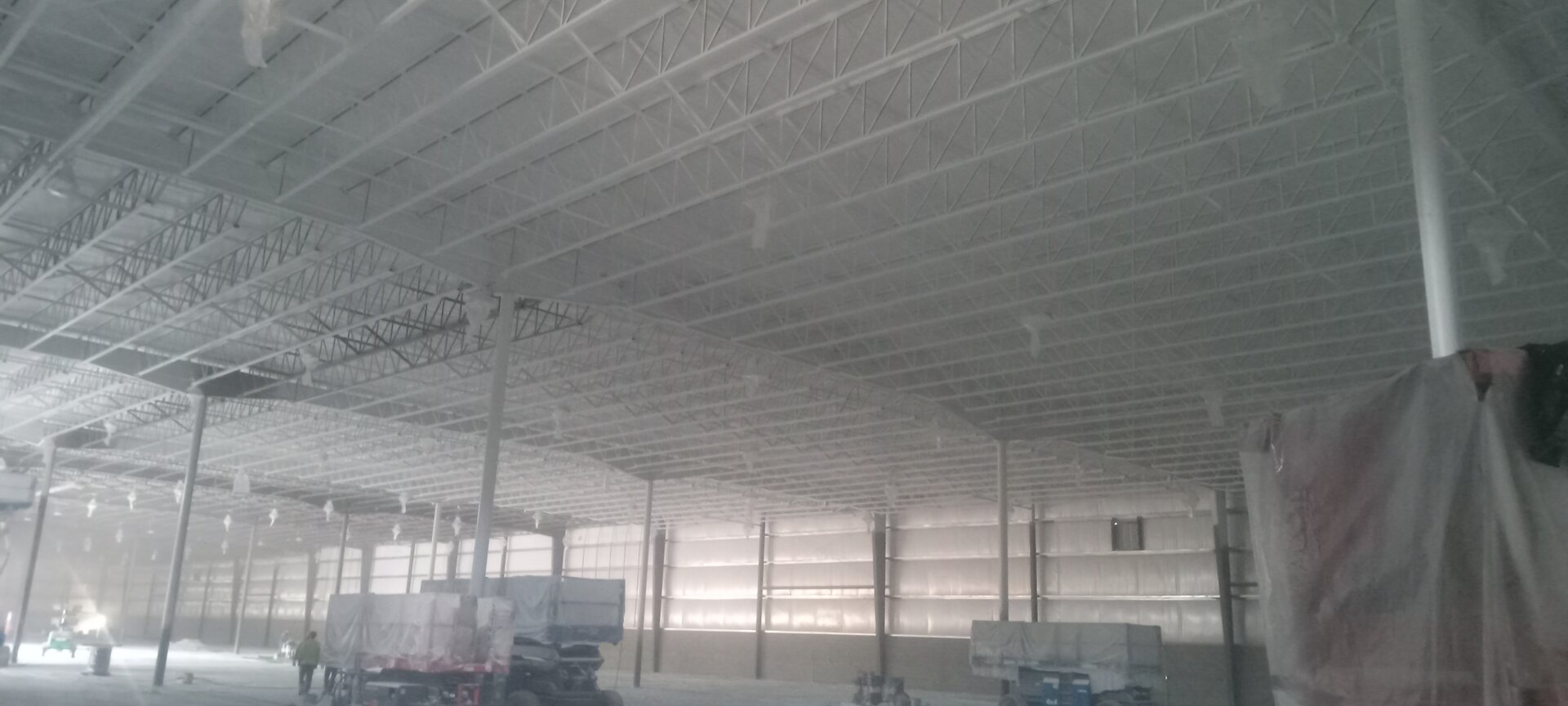Spray painting ceiling steel structure during new construction phase