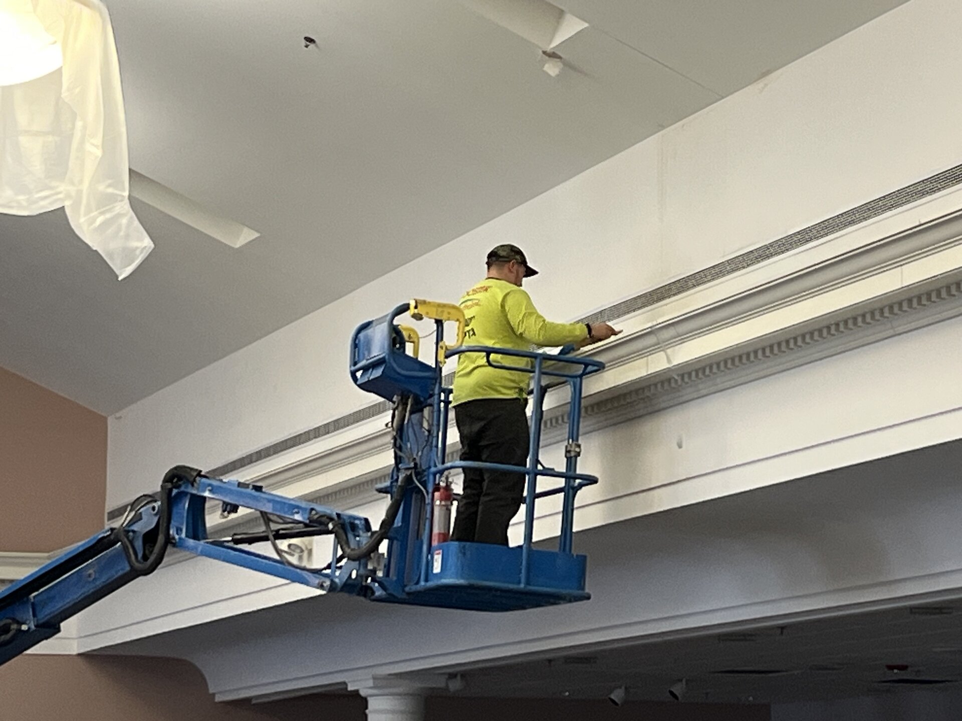 Church interior painting — crew working on wall sections