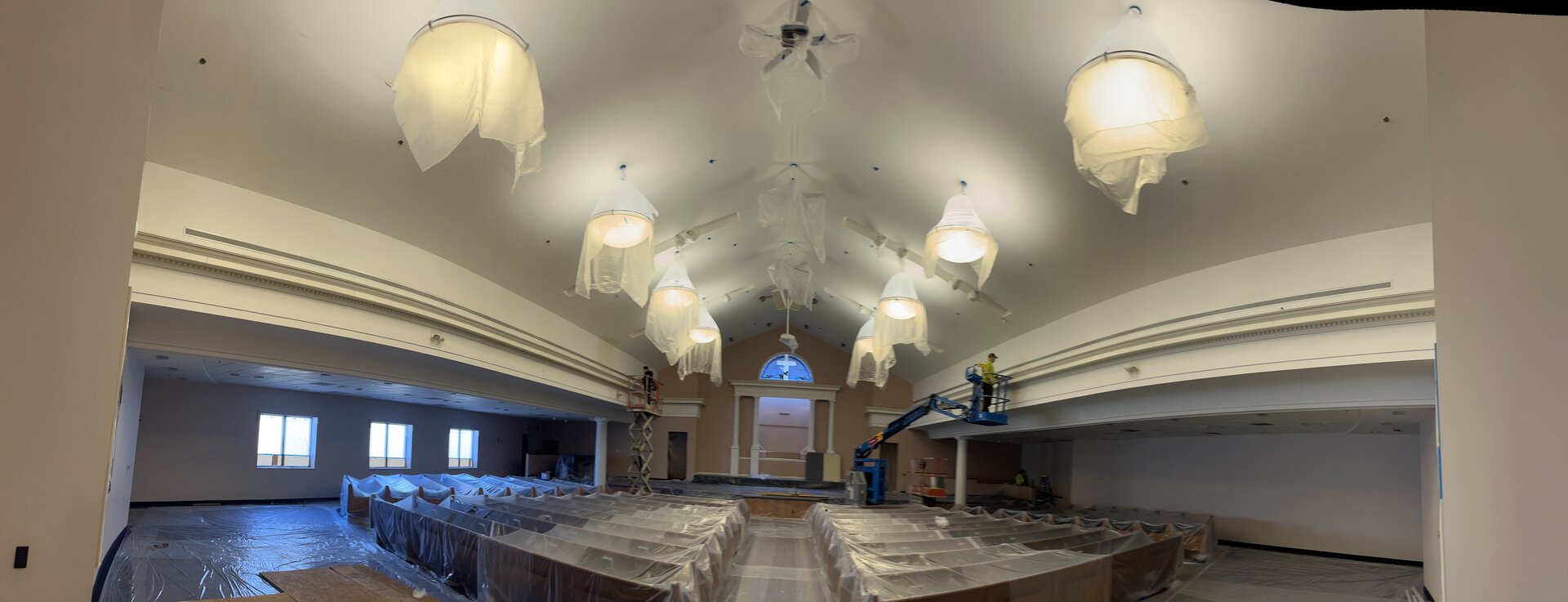 Auditorium side wall painting — detail work in progress