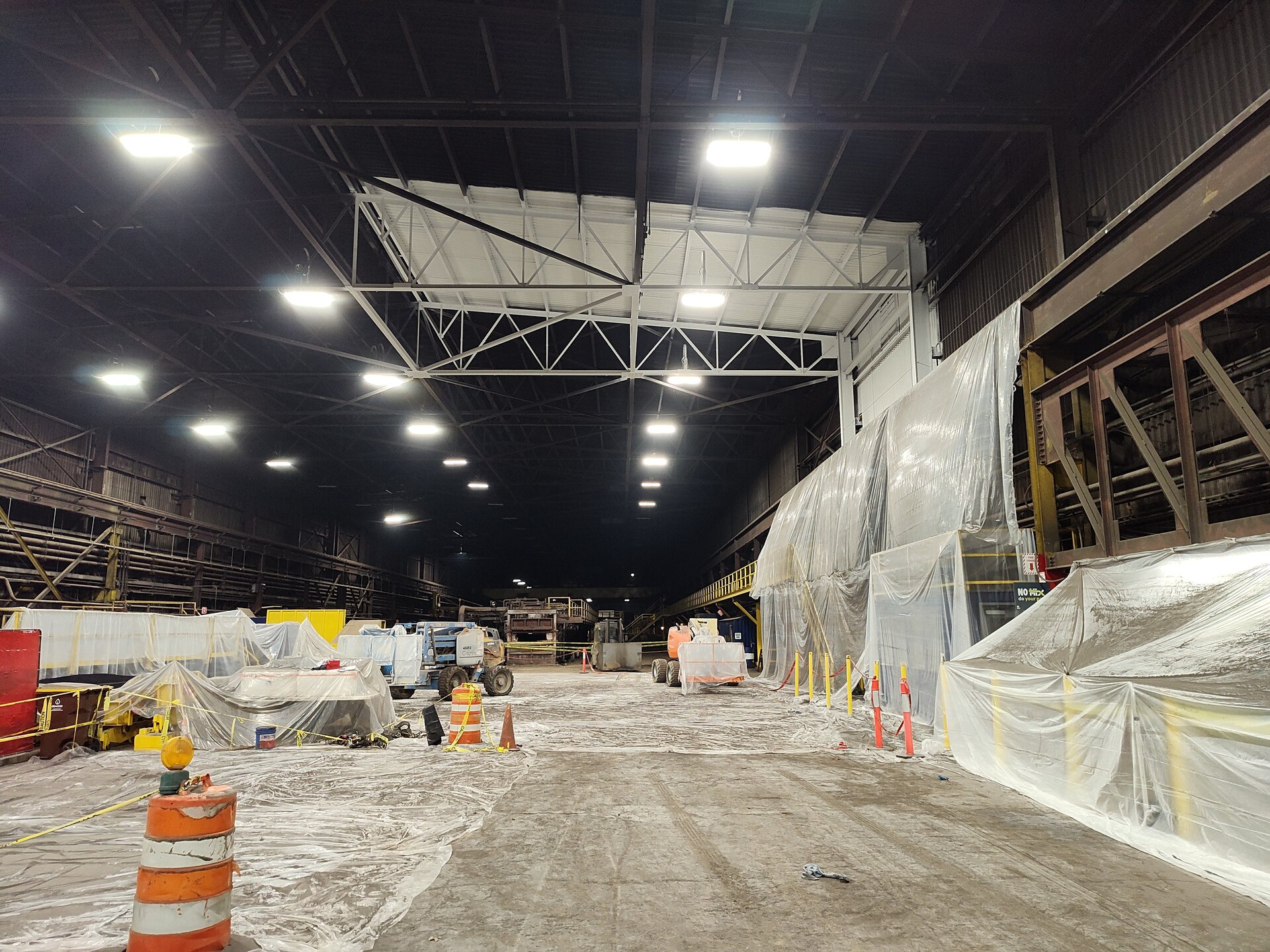 Industrial facility paint sample overview — crew staging in operating steel mill