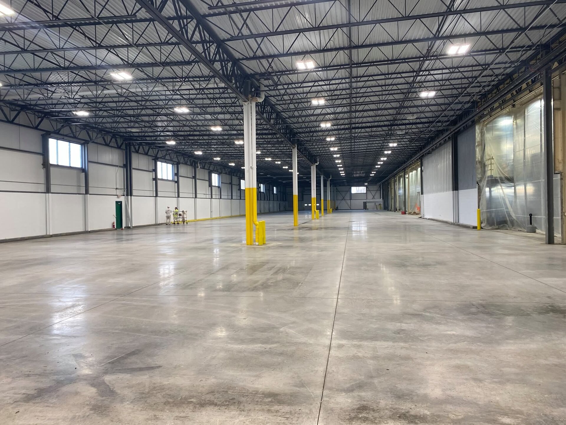 Wide view of new construction warehouse with OSHA compliant safety column paint