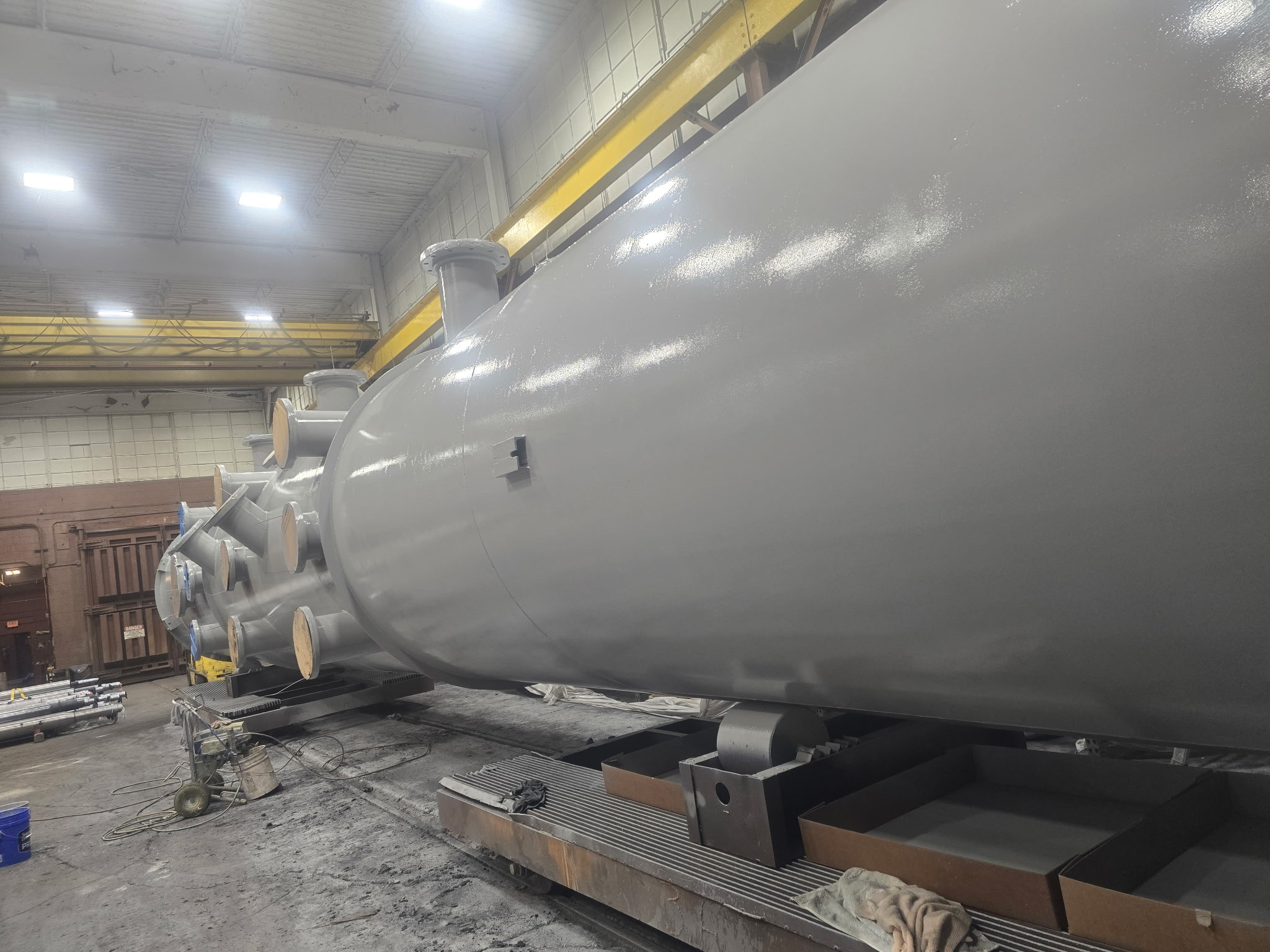 Side view of large horizontal pressure vessel with gray coating