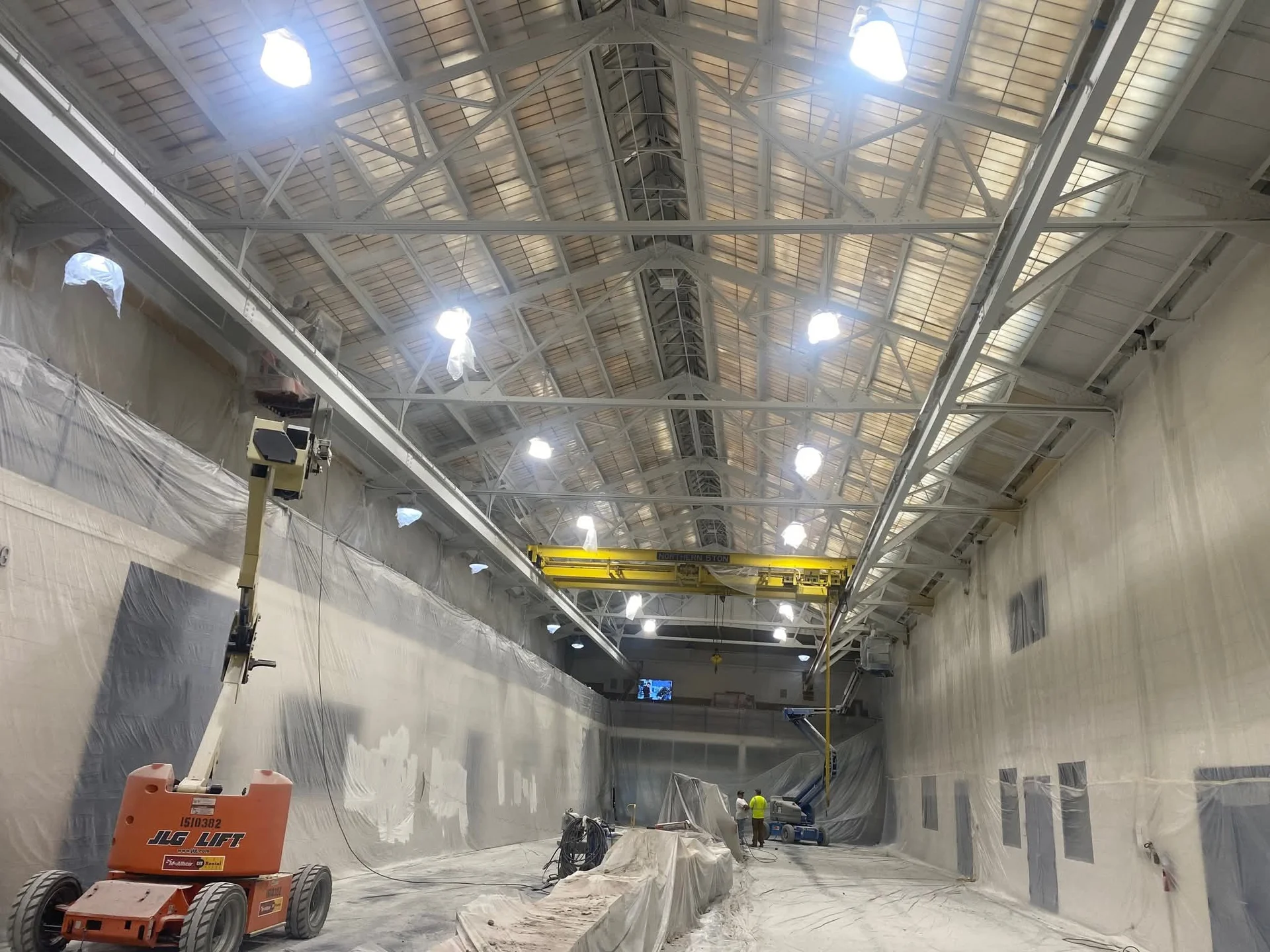 University of Detroit Mercy engineering atrium — full containment and scissor lift during repaint