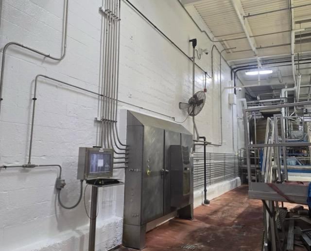 Finished white wall with stainless equipment alongside