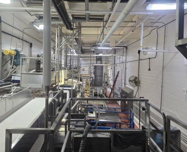 Wide elevated view of production floor with freshly painted walls