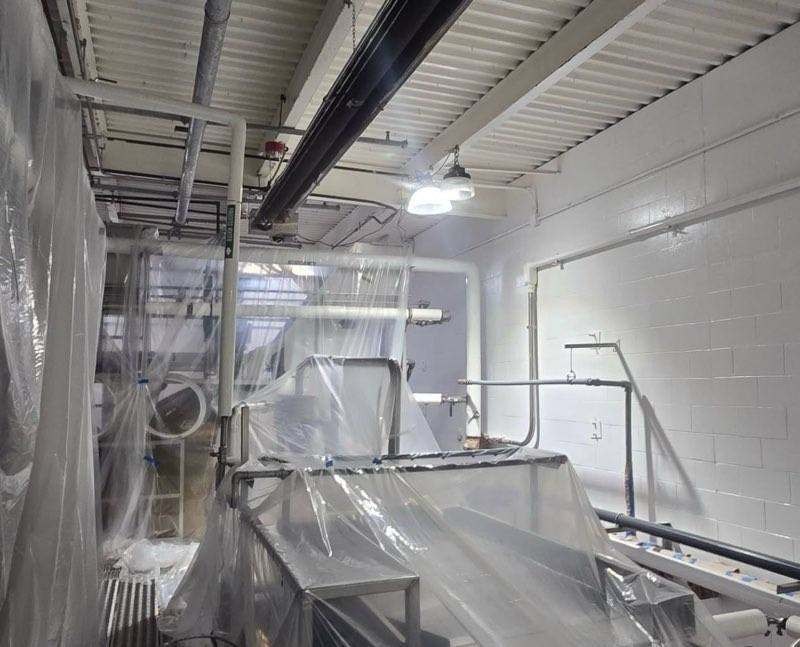 Fresh white walls with equipment masked during painting