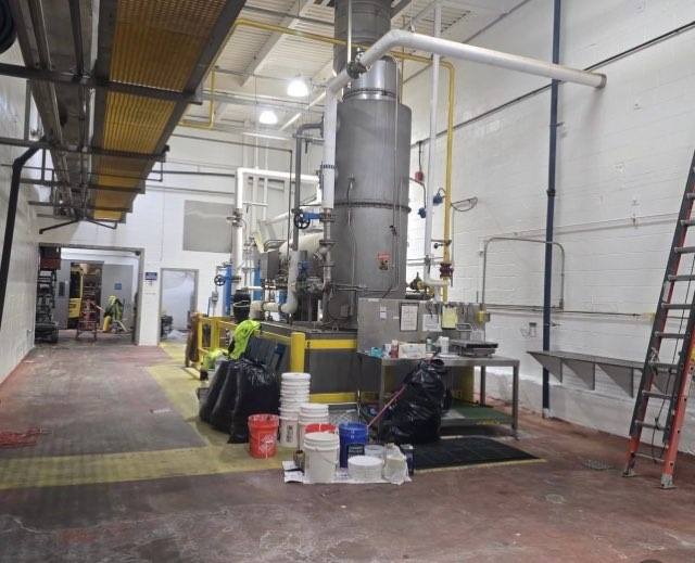 Equipment fully masked with plastic sheeting before painting